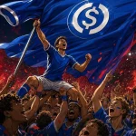 USDC logo on a giant blue football shirt raised above roaring supporters